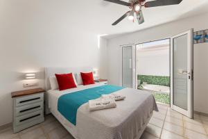 a bedroom with a bed and a balcony with a tub at Serenity Villa Lanzarote by Beyond in San Bartolomé
