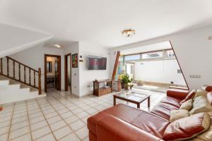 a living room with a couch and a table at Serenity Villa Lanzarote by Beyond in San Bartolomé