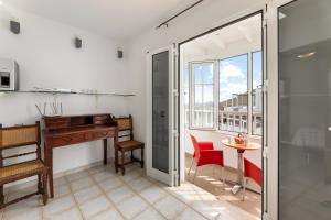 a room with a desk and a table and a desk at Serenity Villa Lanzarote by Beyond in San Bartolomé