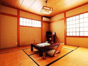 a living room with a table and chairs in it at Lodge Yukiyama in Nozawa Onsen