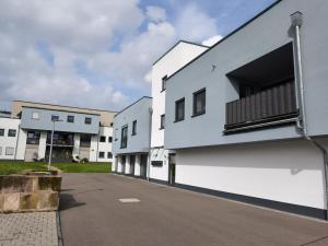 a row of white buildings on a street at Annas Ferienwohnung in Wallerfangen
