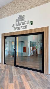 un negozio con una porta a vetri in un edificio di Apto Flor Três Marias-2 Quartos- Apto todo climatizado- Moderno, confortável, à 150m do Parque Termal a Piratuba