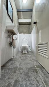 a bathroom with a toilet and a sink at TeamV Kubo Guesthouse in Agdañgan