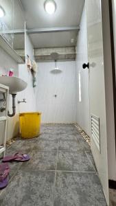 a bathroom with a sink and a yellow tub at TeamV Kubo Guesthouse in Agdañgan +16 photos
