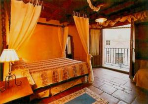 a bedroom with a bed and a large window at Posada Restaurante Ducal in Peñaranda de Duero