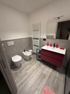 een badkamer met 2 wastafels en een toilet bij Il Paese delle Vacanze by Elisa in Omegna