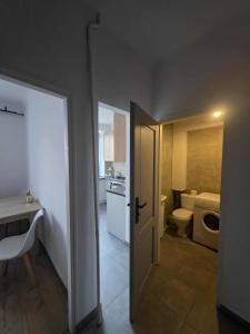 an open door to a small bathroom with a toilet at Kawalerka Krasińskiego in Kraśnik