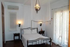 a bedroom with a bed and a chandelier at Keramos Villa in Kerames