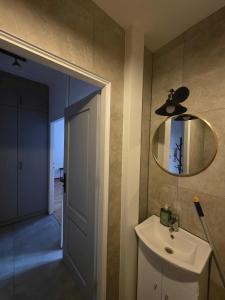 a bathroom with a sink and a mirror on the wall at Kawalerka Krasińskiego in Kraśnik