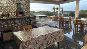 a restaurant with tables and chairs in a room at Hotel Caribe de Alter - Alter do Chão in Santarém