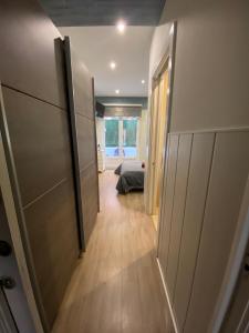 a hallway leading to a bedroom with a bed in a room at APARTAMENTOs URDAIBAI 2 in Bermeo +11 photos