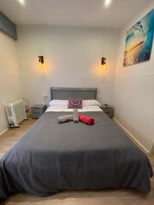 a bedroom with a large bed with a stuffed animal on it at APARTAMENTOs URDAIBAI 2 in Bermeo