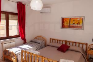 a bedroom with two beds and a window at B&B Lido Azzurro in Catanzaro Lido