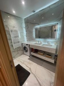 a bathroom with a sink and a mirror at Résidence Royal CasaBlanca in Casablanca +132 photos