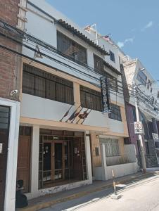 a building on the corner of a street at San Antonio hotel in Puno