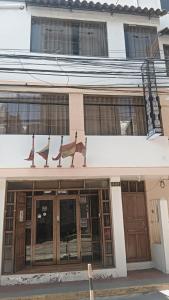 a building with signs on the front of it at San Antonio hotel in Puno