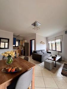 a living room with a table and a couch at Mountain View Apartments in Kalavrita