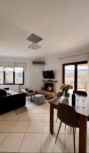 a living room with a couch and a table at Mountain View Apartments in Kalavrita +19 photos
