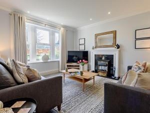 a living room with two couches and a fireplace at 3 Bed in Loweswater 94152 in Arlecdon