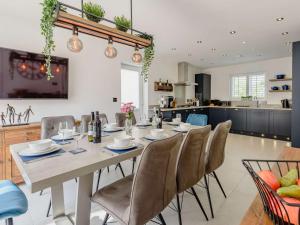 a kitchen and dining room with a table and chairs at 4 Bed in Bradwell 89431 in Bradwell