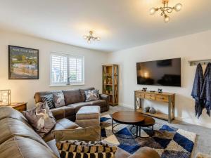 a living room with a couch and a table at 4 Bed in Bradwell 89431 in Bradwell
