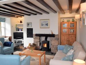 a living room with a couch and a fireplace at 3 bed in Eskdale SZ313 in Boot