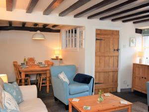 a living room with a table and a blue chair at 3 bed in Eskdale SZ313 in Boot