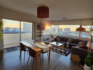 a living room with a table and a couch at Panorama Sea and Mountain Views in Strand