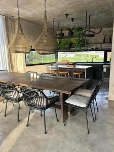 a dining room with a large wooden table and chairs at Casa Rumenco Joven mdq in Mar del Plata +16 photos