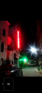 a lit up building with red and green lights at Hotel A K CONTINENTAL in Rānchī