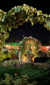 a garden at night with a large arch of flowers at Chardonnay Lodge in Napa