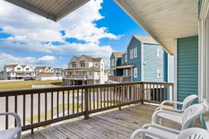 ein Balkon mit weißen Stühlen und einem blauen Haus in der Unterkunft CAC-21A - Turtle in Buxton + 62 Fotos
