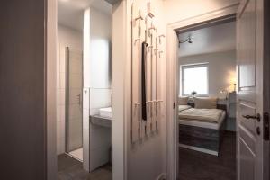 a bathroom with a sink and a bed in a room at Deichkoje 2 Dagebüll in Dagebüll