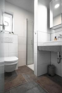 a white bathroom with a toilet and a sink at Deichkoje 2 Dagebüll in Dagebüll +14 photos