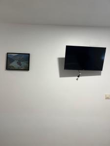 a flat screen tv on a white wall at Pensión Ferreiriño in Quiroga +12 photos