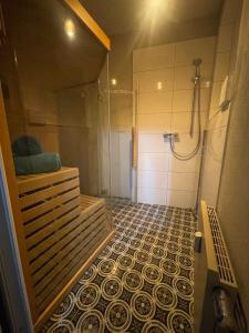 a bathroom with a shower and a tiled floor at See Schmetterling (Fjäril) in Wismar +24 photos