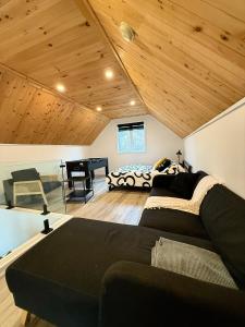 a bedroom with a couch and a bed in a room at Le Chal'Heureux in Saint Adelphe