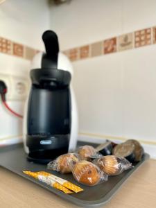 a tray with some pastries and a coffee pot at APARTAMENTOS URDAIBAI 7 in Bermeo +4 photos