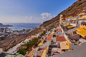 a view of a town on the side of a hill at CASA TONINO in Mogán