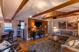 a living room with a couch and a table at Four Bear Falls in Banner Elk