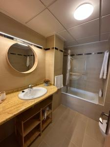 a bathroom with a sink and a shower and a mirror at Pegaso II in San Juan de los Terreros