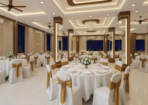 a banquet hall with white tables and chairs at Hotel A K CONTINENTAL in Rānchī