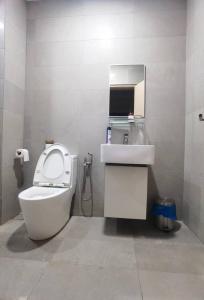 a bathroom with a toilet and a sink at Seaview Jacuzzi Starry - 5 pax in Melaka +16 photos