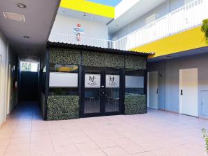 a building with glass doors in a building at Capital Hotel in Monclova