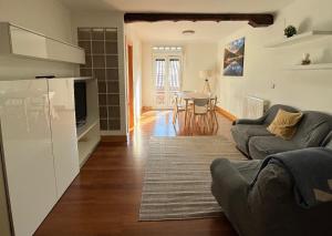 a living room with a couch and a table at APARTAMENTOs URDAIBAI 6 in Bermeo