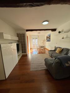 a kitchen and living room with a couch and a table at APARTAMENTOs URDAIBAI 6 in Bermeo +17 photos