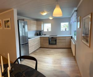a kitchen with a stainless steel refrigerator and a table at Two rooms apartment in Reykjavik in Reykjavík