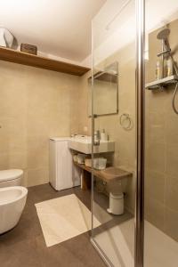 a bathroom with a toilet and a sink and a shower at Monolocale in centro a Madesimo in Madesimo +21 photos