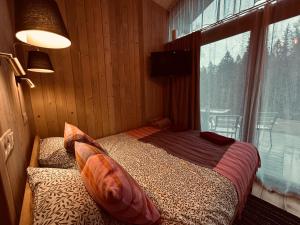 a bedroom with a bed and a large window at Braslas čuksti in Brasla +40 photos