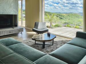 ein Wohnzimmer mit Sofa, Sessel und Fernseher in der Unterkunft LuxApart Eifel mit privater Sauna in Harscheid + 12 Fotos